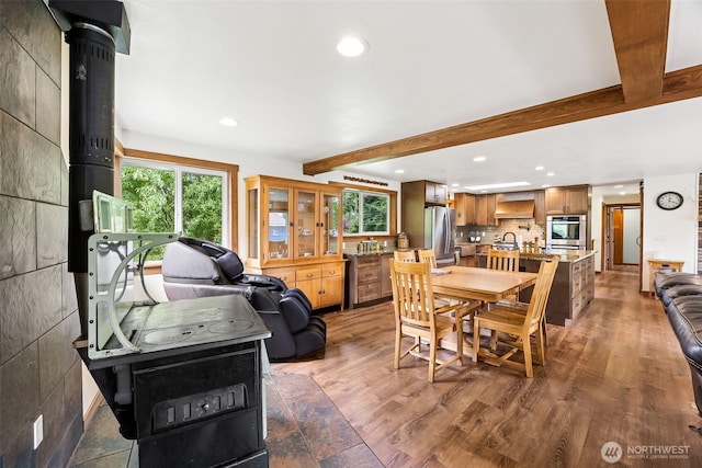 9317 214th Ave E, Bonney Lake, WA 98391 - dining area featuring beam ceiling, recessed lighting, plenty of natural light, and wood finished floors