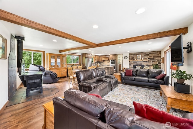 9317 214th Ave E, Bonney Lake, WA 98391 - living area featuring a wood stove, beam ceiling, recessed lighting, and wood finished floors