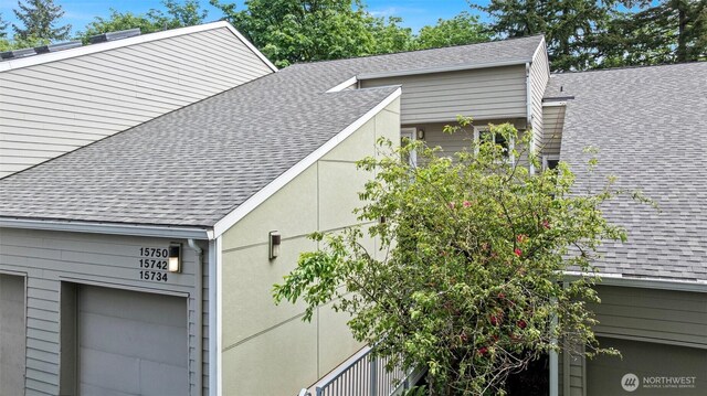 15734 NE 70th Ct Unit 15734, Redmond, WA 98052 - view of side of property featuring a shingled roof and a garage