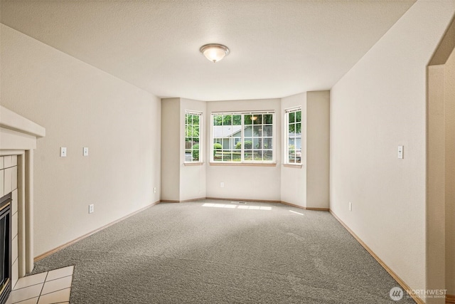 3724 30th Ave SE, Olympia, WA 98501 - unfurnished living room with a tile fireplace and light colored carpet