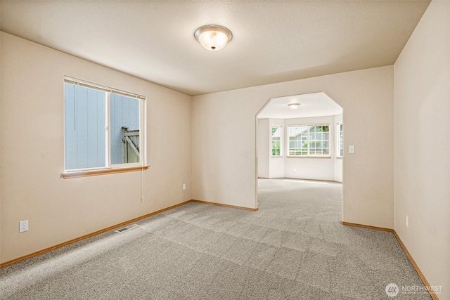 3724 30th Ave SE, Olympia, WA 98501 - spare room featuring arched walkways and carpet floors