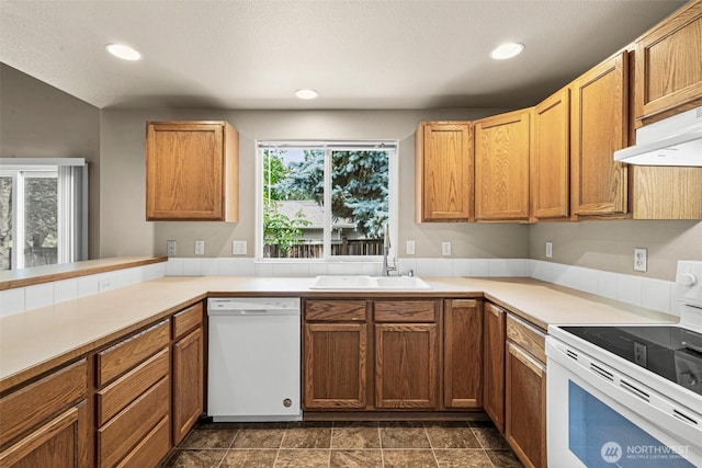 3724 30th Ave SE, Olympia, WA 98501 - kitchen with white appliances, recessed lighting, light countertops, under cabinet range hood, and brown cabinetry