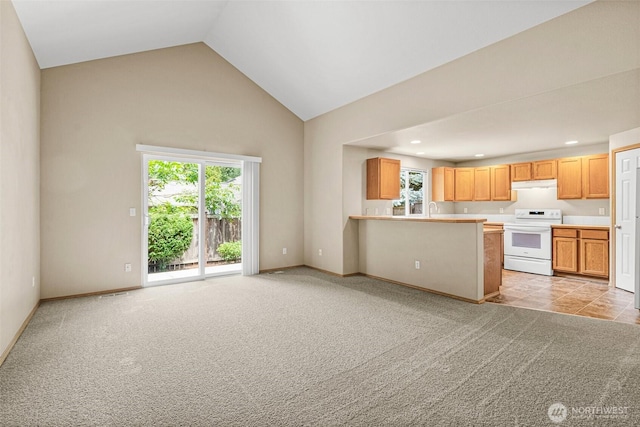 3724 30th Ave SE, Olympia, WA 98501 - kitchen with white range with electric stovetop, light carpet, under cabinet range hood, high vaulted ceiling, and light countertops