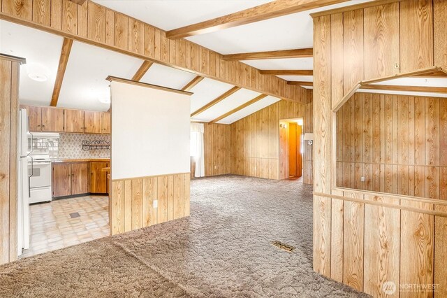 2240 W Broadway Ave Unit 22, Moses Lake, WA 98837 - kitchen with white electric range, wooden walls, tasteful backsplash, carpet floors, and open floor plan
