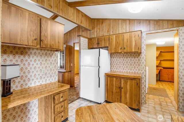 2240 W Broadway Ave Unit 22, Moses Lake, WA 98837 - kitchen featuring freestanding refrigerator, light countertops, brown cabinetry, wallpapered walls, and light flooring