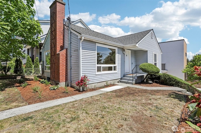 8902 17th Ave NE, Seattle, WA 98115 - bungalow-style home featuring a chimney, roof with shingles, and a front yard