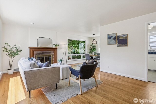 8902 17th Ave NE, Seattle, WA 98115 - living room featuring light wood finished floors, healthy amount of natural light, and a fireplace