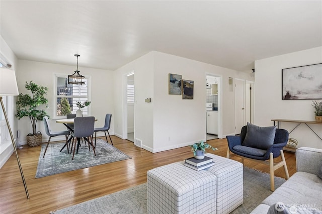 8902 17th Ave NE, Seattle, WA 98115 - living area featuring a chandelier and light wood-style flooring