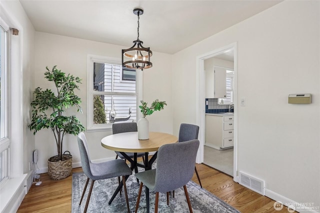 8902 17th Ave NE, Seattle, WA 98115 - dining area featuring light wood finished floors and a chandelier