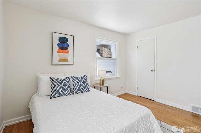 8902 17th Ave NE, Seattle, WA 98115 - bedroom featuring wood finished floors and baseboards
