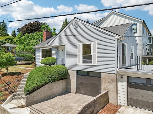 8902 17th Ave NE, Seattle, WA 98115 - bungalow-style house with a garage, driveway, and a chimney
