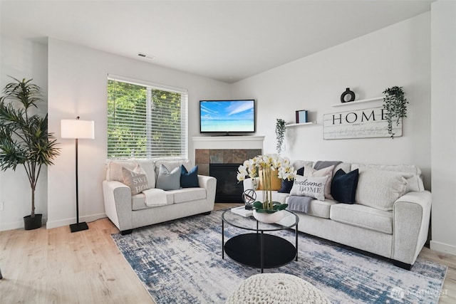 1341 52nd St NE Unit 1205, Auburn, WA 98002 - living room featuring wood finished floors and a tiled fireplace
