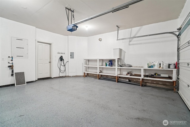 1341 52nd St NE Unit 1205, Auburn, WA 98002 - garage featuring a garage door opener and electric panel