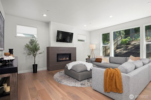 1142 Brookstone Dr, Bellingham, WA 98229 - living room featuring a tile fireplace, wood finished floors, and recessed lighting