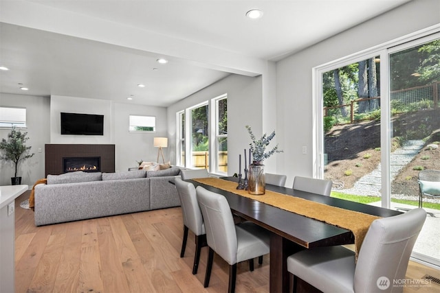1142 Brookstone Dr, Bellingham, WA 98229 - dining area with light wood-type flooring, healthy amount of natural light, recessed lighting, and a glass covered fireplace