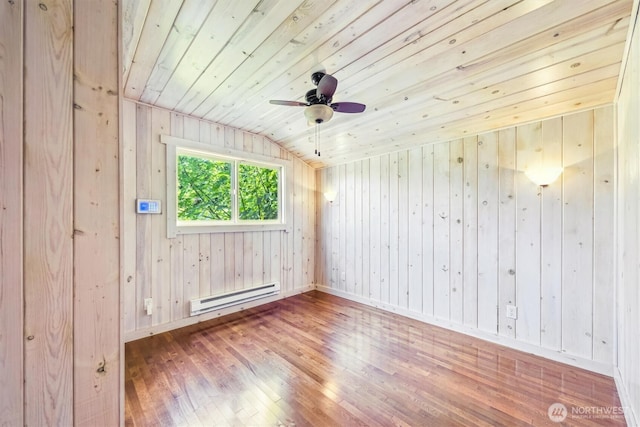 13540 E State Route 106, Belfair, WA 98528 - empty room featuring a baseboard radiator, wood finished floors, wooden ceiling, lofted ceiling, and wood walls