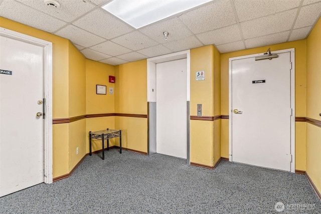 722 N 85th St Unit 41, Seattle, WA 98103 - carpeted empty room with a paneled ceiling, a pendent fire sprinkler, a smoke detector, and elevator