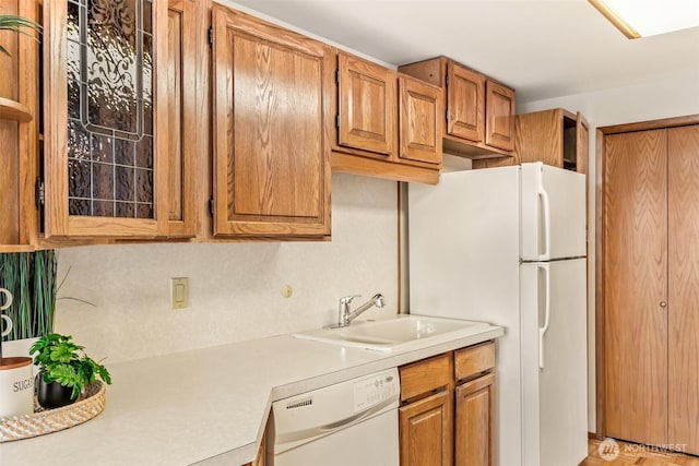 722 N 85th St Unit 41, Seattle, WA 98103 - kitchen with white appliances, light countertops, and brown cabinetry