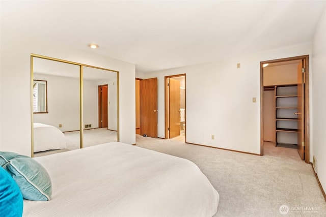 722 N 85th St Unit 41, Seattle, WA 98103 - bedroom with light colored carpet, a closet, ensuite bath, and a walk in closet