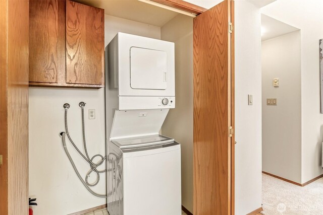 722 N 85th St Unit 41, Seattle, WA 98103 - laundry room featuring stacked washer / dryer and baseboards