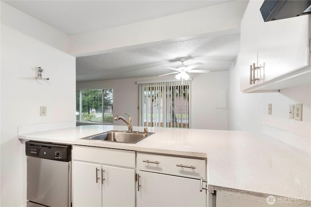 3834 D Pl SE, Auburn, WA 98002 - kitchen featuring dishwasher, range hood, a peninsula, white cabinetry, and a textured ceiling