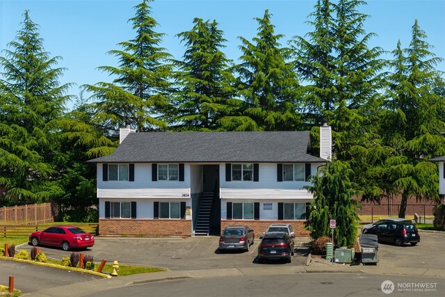 3834 D Pl SE, Auburn, WA 98002 - view of front facade with a chimney, brick siding, and uncovered parking
