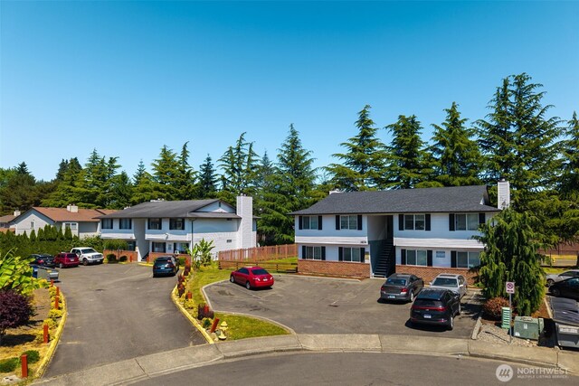 3834 D Pl SE, Auburn, WA 98002 - townhome / multi-family property with uncovered parking, a chimney, and brick siding