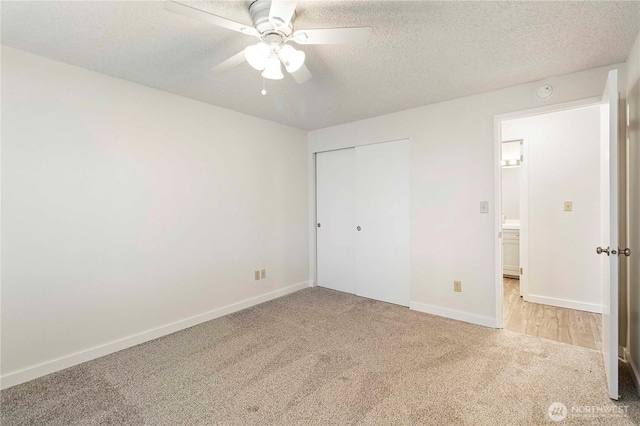 3834 D Pl SE, Auburn, WA 98002 - unfurnished bedroom featuring light colored carpet, a textured ceiling, a closet, and a ceiling fan
