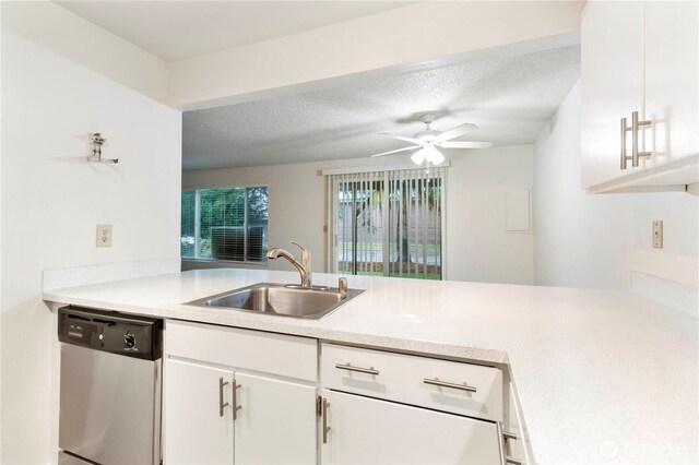 3834 D Pl SE, Auburn, WA 98002 - kitchen with stainless steel dishwasher, a peninsula, light countertops, white cabinetry, and a textured ceiling