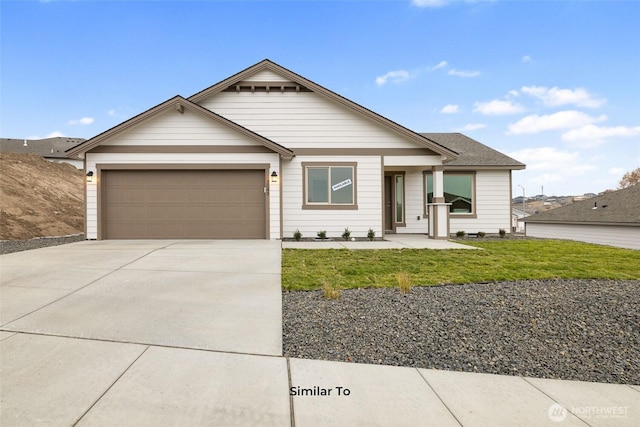 314 N Sandy Loop, Moses Lake, WA 98837 - view of front of home with a garage, driveway, and a front lawn