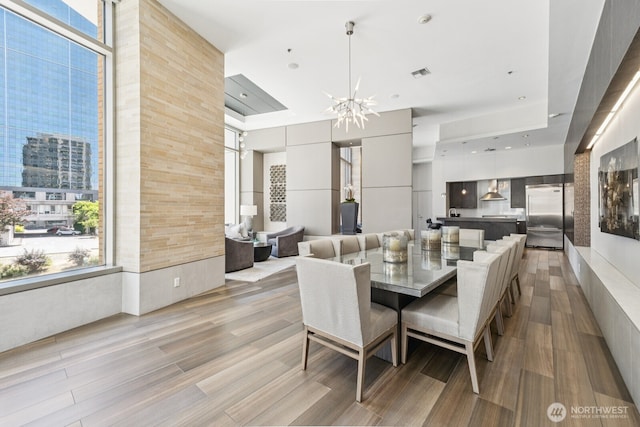 10610 NE 9th Pl Unit C4210, Bellevue, WA 98004 - dining room featuring a chandelier, light wood finished floors, and a view of city
