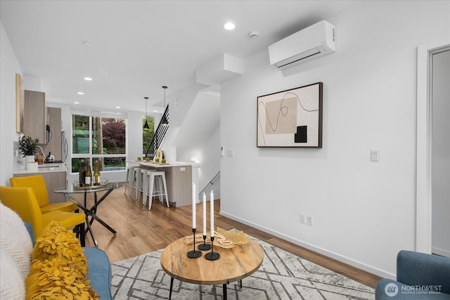 9030 18th Ave SW Unit E, Seattle, WA 98106 - living room featuring a wall mounted AC, wood finished floors, and recessed lighting