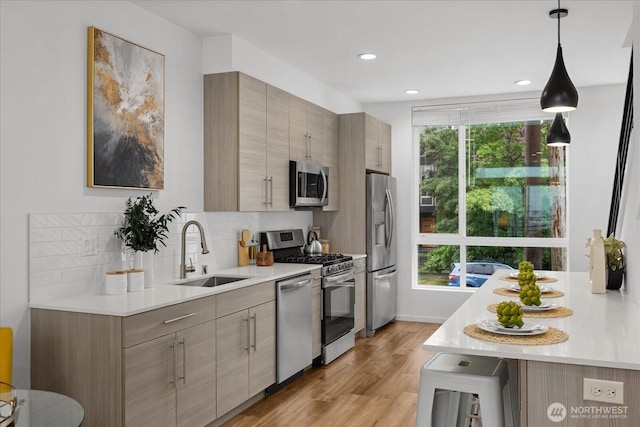 9030 18th Ave SW Unit E, Seattle, WA 98106 - kitchen with appliances with stainless steel finishes, light countertops, backsplash, and recessed lighting