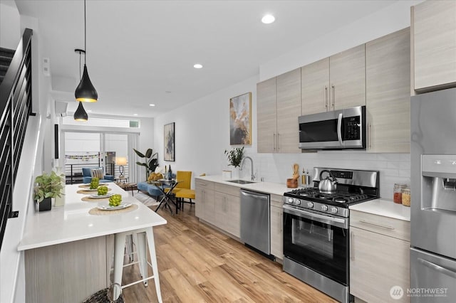 9030 18th Ave SW Unit E, Seattle, WA 98106 - kitchen with stainless steel appliances, tasteful backsplash, modern cabinets, light countertops, and recessed lighting