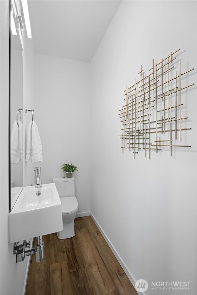 9030 18th Ave SW Unit E, Seattle, WA 98106 - half bathroom with wood finished floors and toilet