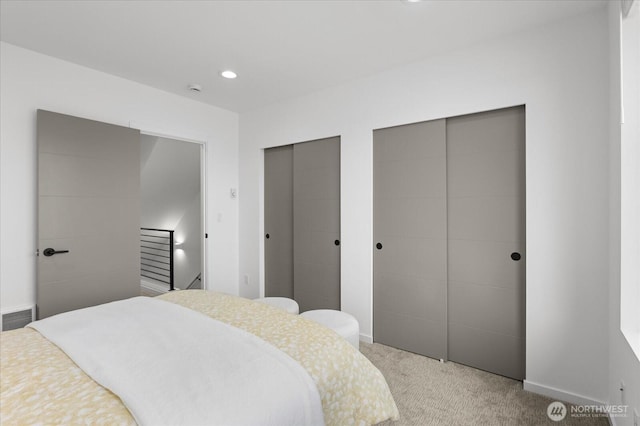 9030 18th Ave SW Unit E, Seattle, WA 98106 - bedroom featuring two closets, light colored carpet, and recessed lighting