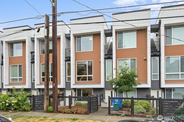 9030 18th Ave SW Unit E, Seattle, WA 98106 - view of building exterior featuring a fenced front yard
