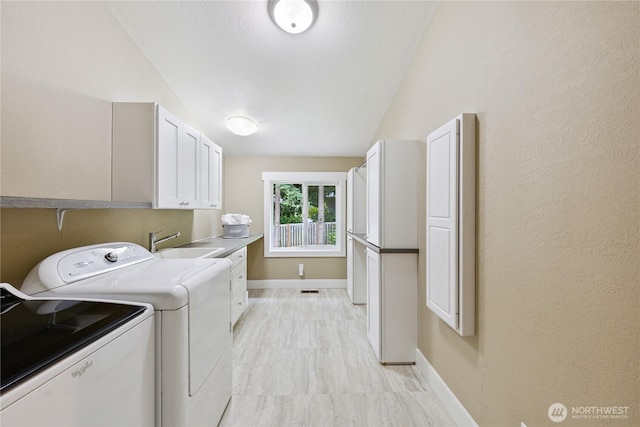 2515 16th St, Anacortes, WA 98221 - laundry area featuring cabinet space and separate washer and dryer