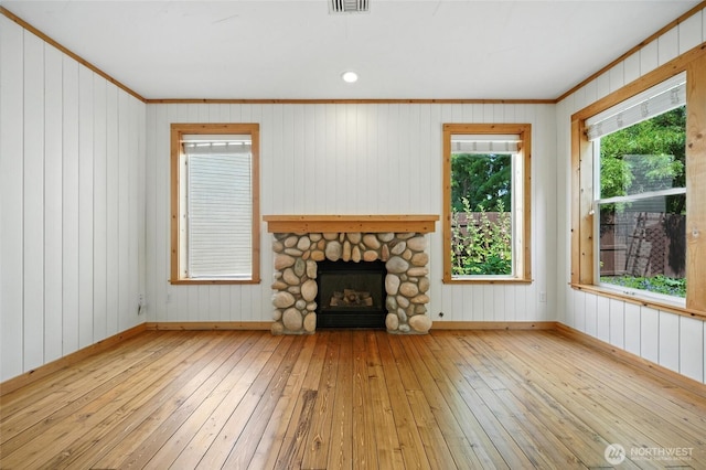847 SE Covey Ct, College Place, WA 99324 - unfurnished living room featuring wood-type flooring, a fireplace, ornamental molding, and wood walls