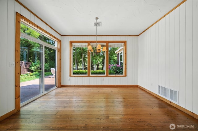 847 SE Covey Ct, College Place, WA 99324 - unfurnished dining area featuring ornamental molding, a chandelier, and hardwood / wood-style flooring
