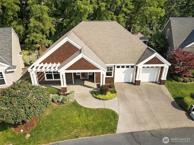 847 SE Covey Ct, College Place, WA 99324 - craftsman house featuring a garage, concrete driveway, roof with shingles, and a front lawn
