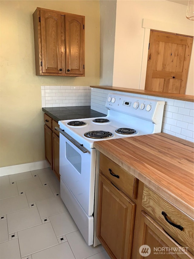 316 N F, Aberdeen, WA 98520 - kitchen with electric stove, backsplash, brown cabinets, and light floors