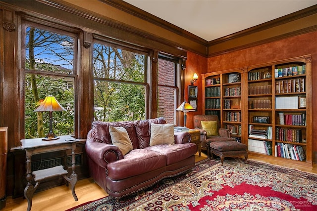 living area featuring crown molding and wood finished floors