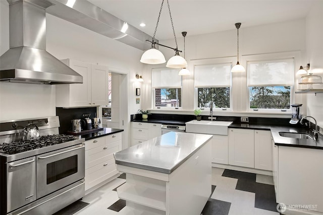 kitchen with double oven range, wall chimney range hood, white cabinetry, recessed lighting, and hanging light fixtures
