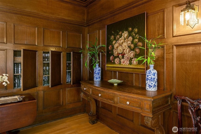 office featuring wood walls and light wood finished floors