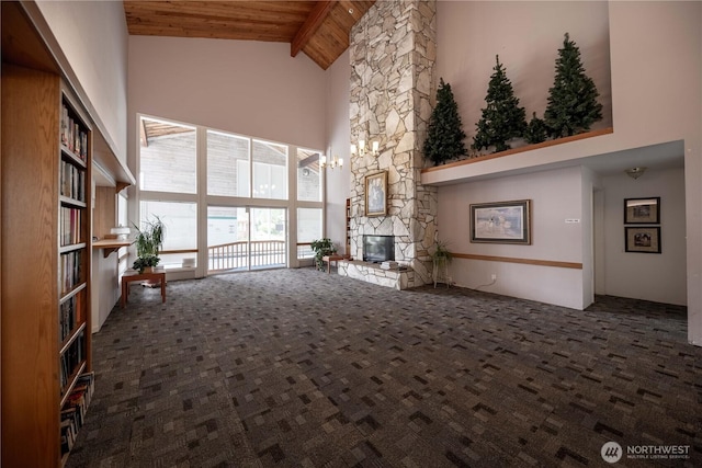 2610 E Section St Unit 20, Mount Vernon, WA 98274 - unfurnished living room featuring high vaulted ceiling, a wooden ceiling with exposed beams, carpet, and a stone fireplace