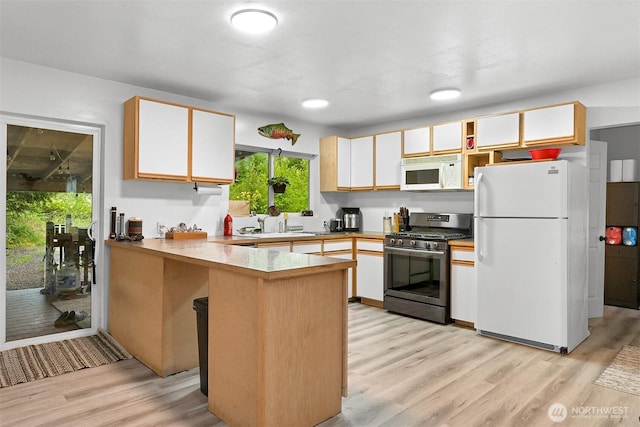 6258 Bellwood Dr, Maple Falls, WA 98266 - kitchen featuring white appliances, a peninsula, light wood-style flooring, white cabinetry, and light countertops