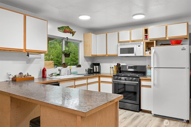 6258 Bellwood Dr, Maple Falls, WA 98266 - kitchen with white appliances, a peninsula, light wood-type flooring, white cabinets, and open shelves