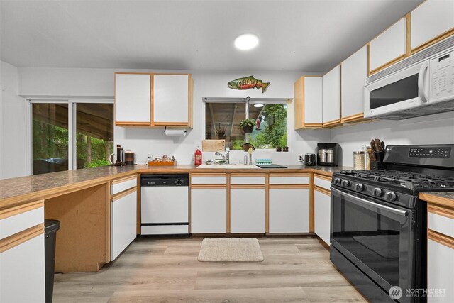 6258 Bellwood Dr, Maple Falls, WA 98266 - kitchen featuring white appliances, white cabinetry, light wood-type flooring, and healthy amount of natural light