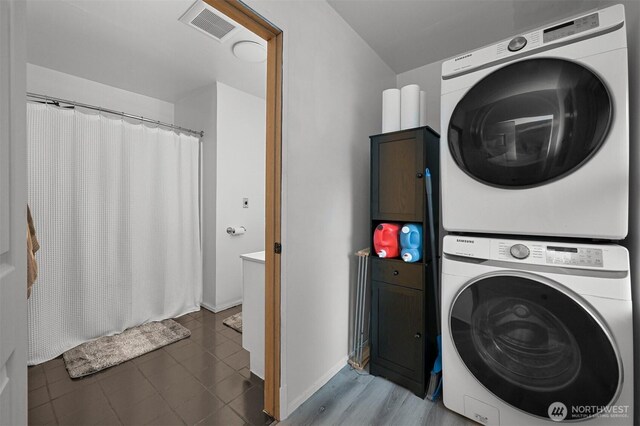 6258 Bellwood Dr, Maple Falls, WA 98266 - laundry area featuring stacked washer and clothes dryer and cabinet space
